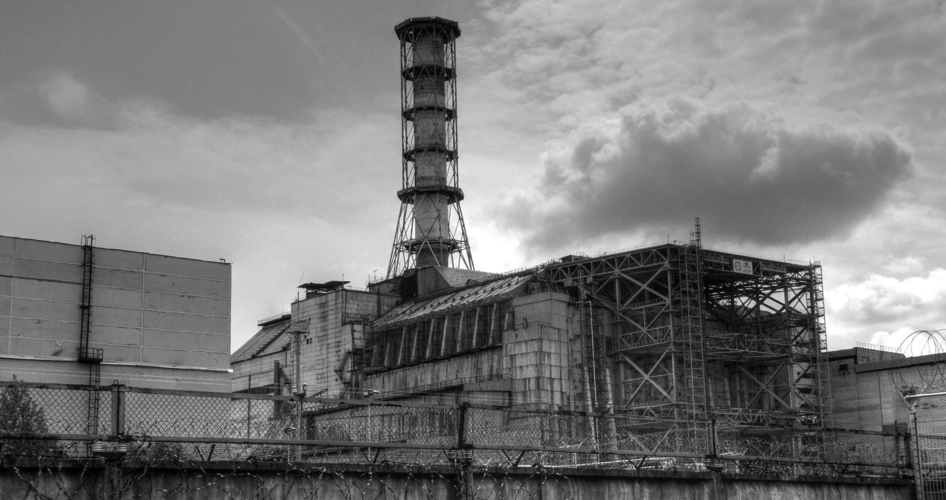 Finstere Schwarz-Weiß-Aufnahme der versiegelten Atomkraftwerksruine in Tschernobyl.